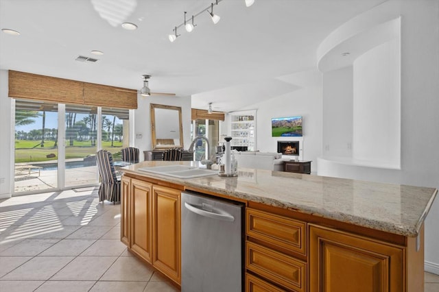 kitchen featuring stainless steel dishwasher, ceiling fan, sink, and a wealth of natural light