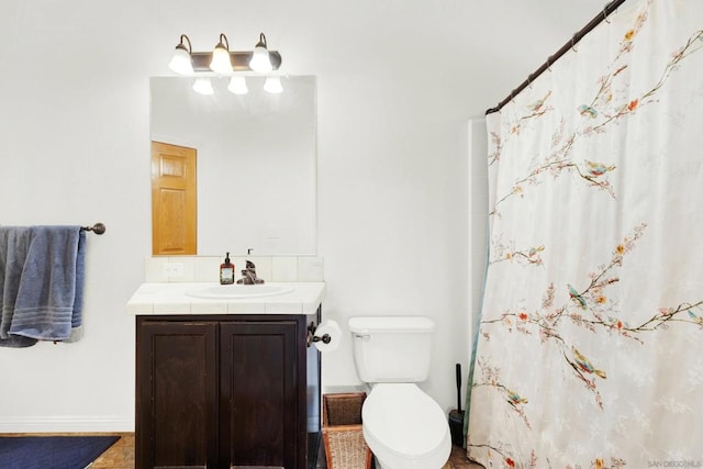 bathroom with curtained shower, tile patterned floors, vanity, and toilet