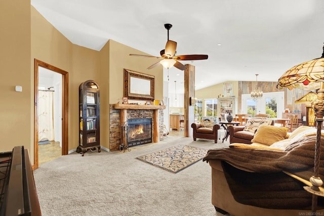 carpeted living room featuring ceiling fan with notable chandelier and vaulted ceiling