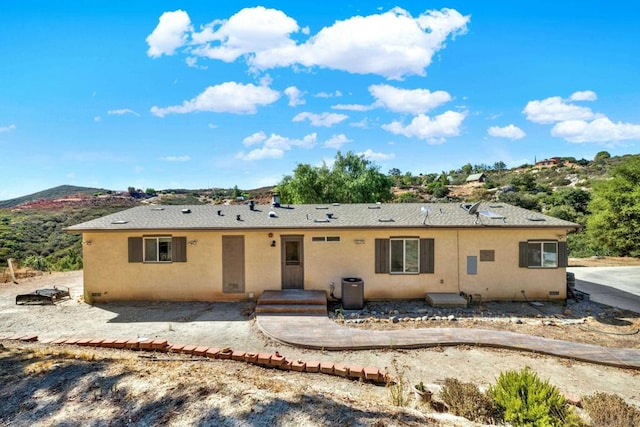 back of house with a patio and a mountain view