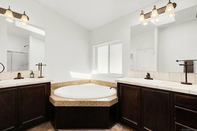 bathroom featuring lofted ceiling, separate shower and tub, and vanity