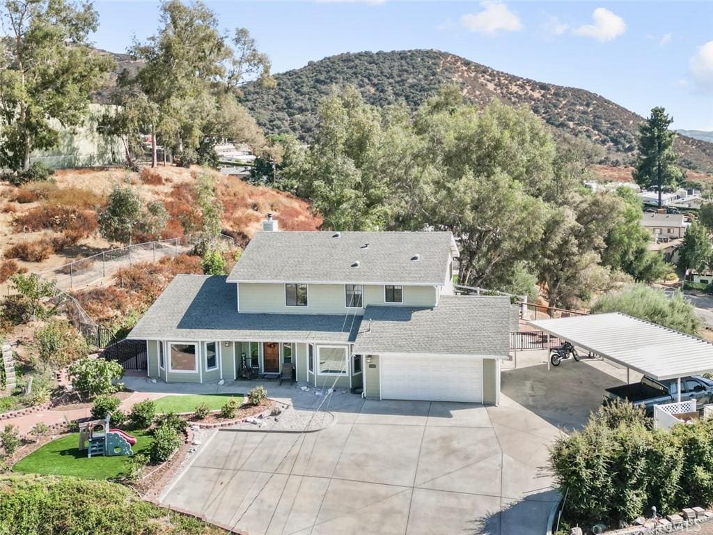 exterior space featuring a garage and a mountain view