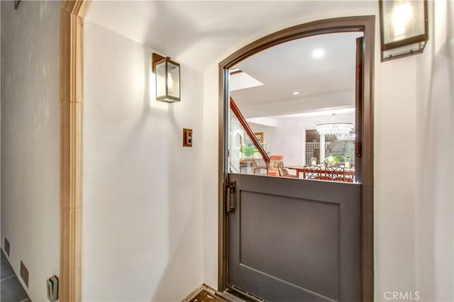 doorway with a chandelier