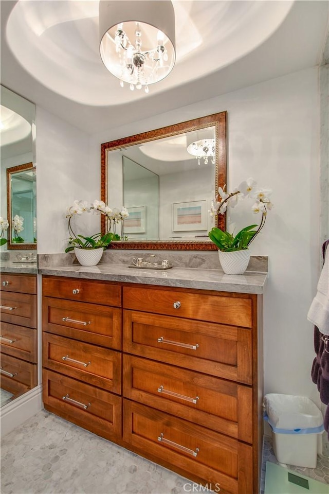 bathroom featuring a tray ceiling and vanity