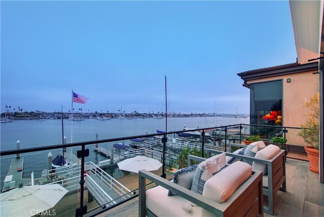 balcony featuring outdoor lounge area and a water view