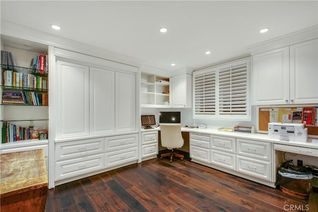 office space with dark hardwood / wood-style flooring and built in desk