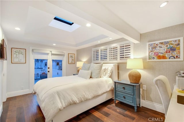 bedroom with dark hardwood / wood-style flooring, access to outside, and a skylight