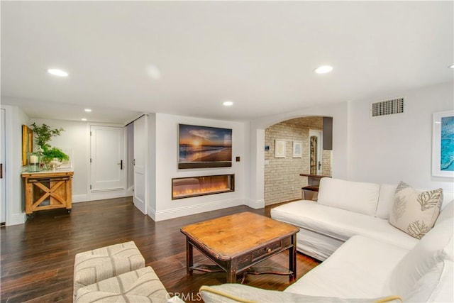 living room with dark hardwood / wood-style flooring