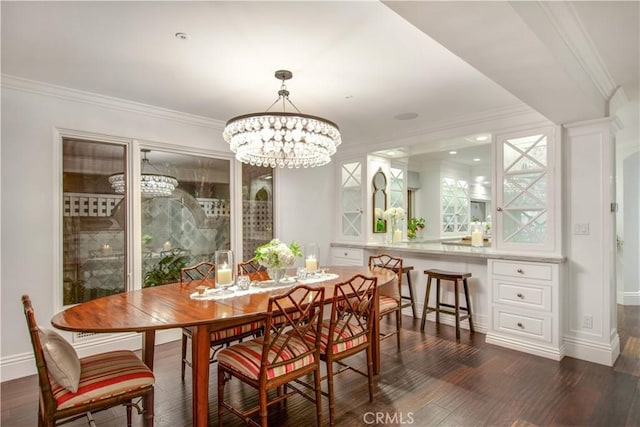 dining room featuring crown molding, dark hardwood / wood-style floors, and an inviting chandelier