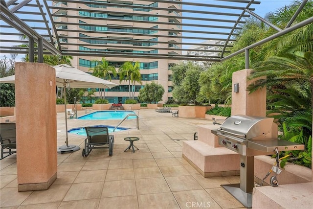 view of patio featuring a community pool and grilling area