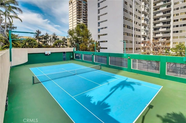 view of tennis court featuring fence