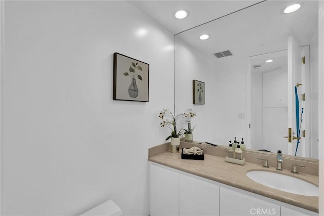 bathroom featuring recessed lighting, visible vents, vanity, and toilet