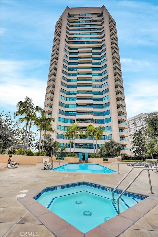 view of pool featuring a patio area and a community hot tub