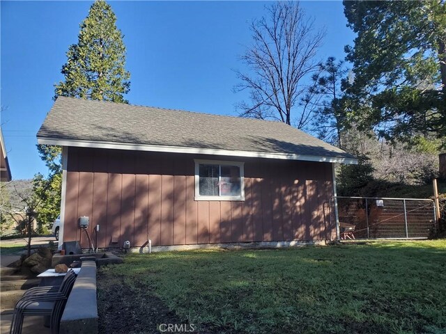 view of side of home with a yard