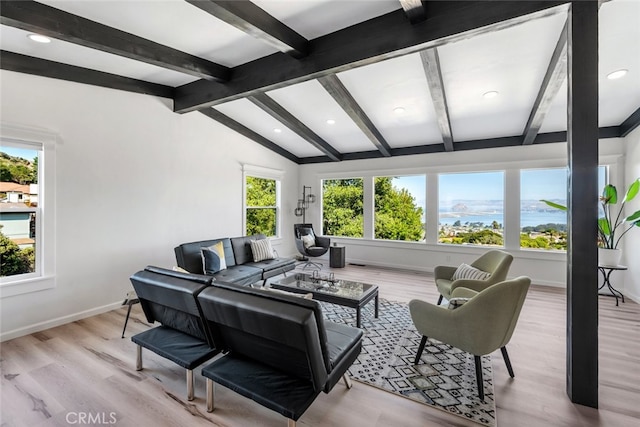 living room featuring light wood-type flooring, a water view, and lofted ceiling with beams