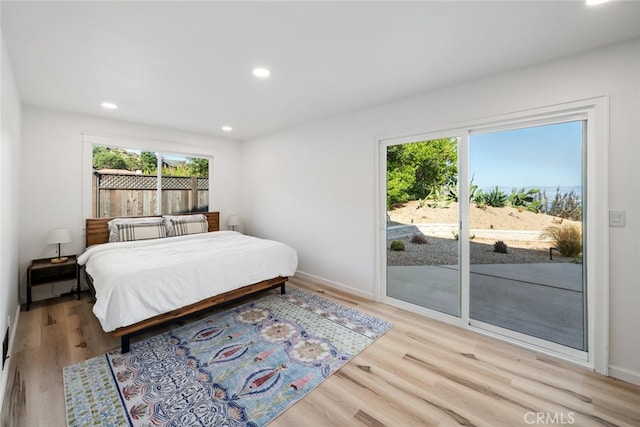 bedroom featuring access to outside and light hardwood / wood-style flooring