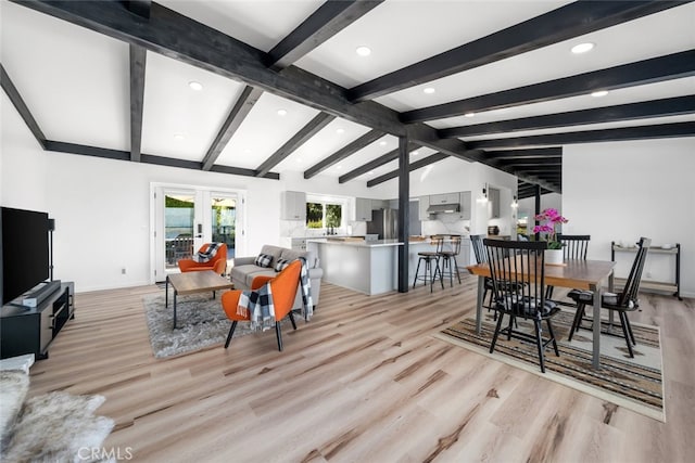 dining area featuring vaulted ceiling with beams, light hardwood / wood-style floors, and french doors