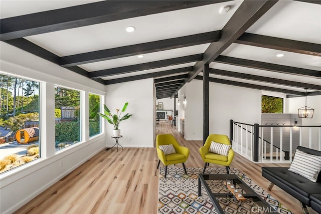 sunroom with an inviting chandelier and vaulted ceiling with beams