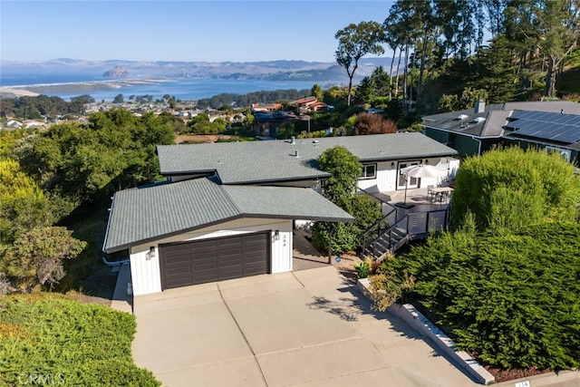 birds eye view of property with a water and mountain view