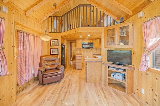 living room featuring wood ceiling, beam ceiling, and wood walls