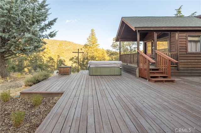 wooden terrace featuring a hot tub