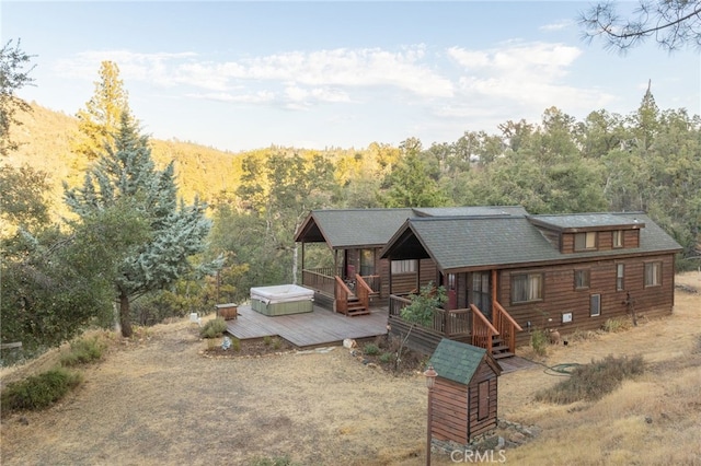 exterior space with a deck and a hot tub