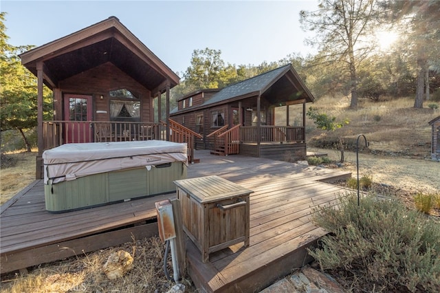 wooden deck with a hot tub