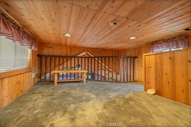 additional living space with wood ceiling, carpet flooring, and wooden walls