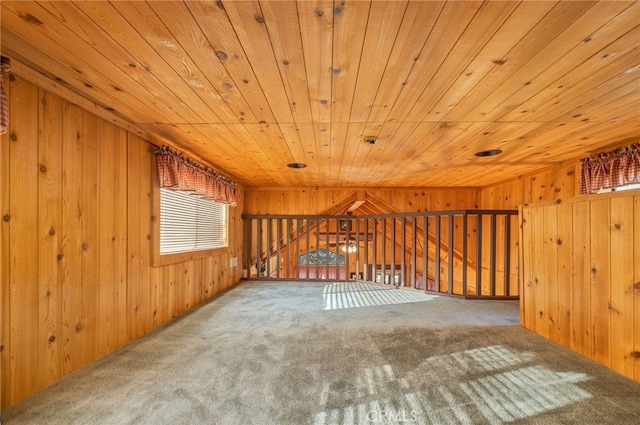 additional living space with wooden walls, wooden ceiling, and carpet flooring