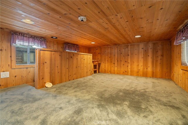 additional living space with wooden ceiling, carpet flooring, and wood walls