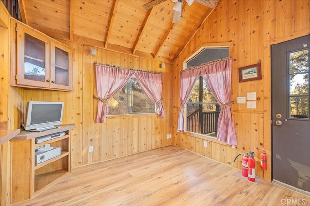 interior space with wood ceiling, wooden walls, light hardwood / wood-style flooring, and plenty of natural light