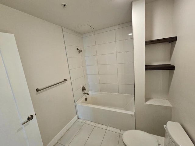 bathroom with tiled shower / bath, tile patterned floors, and toilet