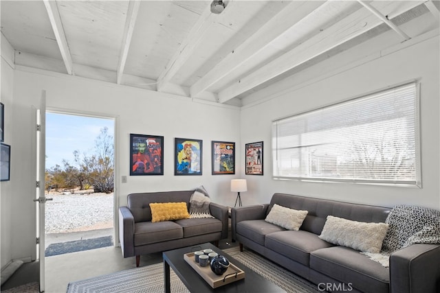 living room with concrete floors and beamed ceiling