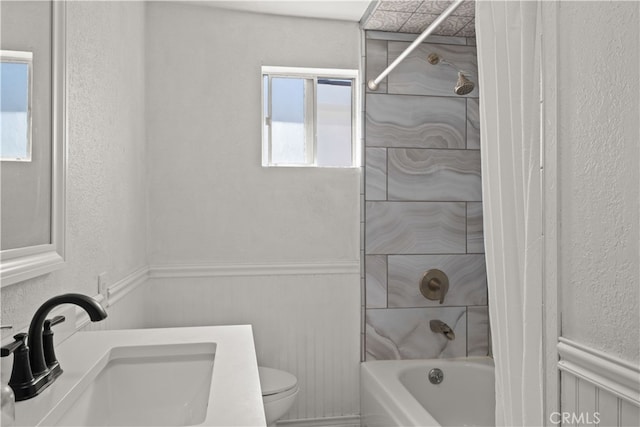 full bathroom featuring vanity, shower / bath combo with shower curtain, and toilet