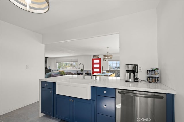 kitchen featuring blue cabinetry, dishwasher, light stone countertops, and sink