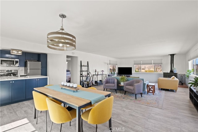 dining room featuring an inviting chandelier and light hardwood / wood-style flooring