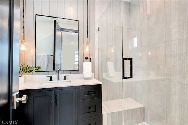 bathroom with vanity and a shower with door