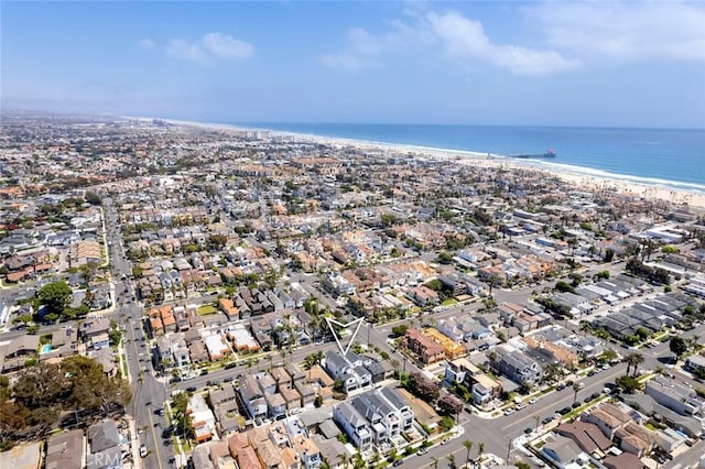 birds eye view of property featuring a water view and a view of the beach