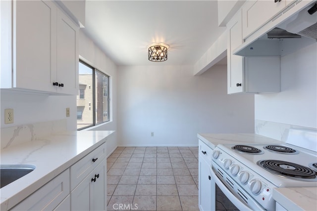 kitchen featuring white cabinets, white range with electric stovetop, light stone counters, and light tile patterned floors