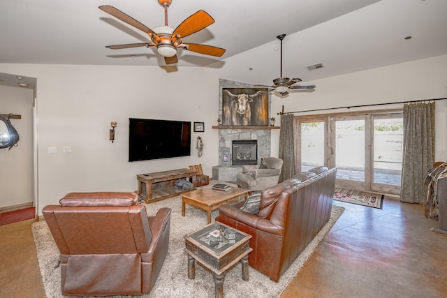 living room with vaulted ceiling, ceiling fan, and a stone fireplace