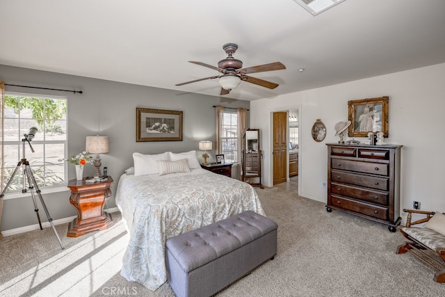 bedroom with light carpet, multiple windows, and ceiling fan