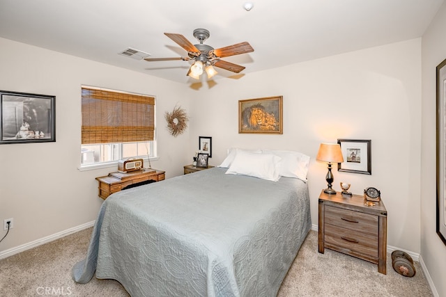 bedroom with ceiling fan and light carpet