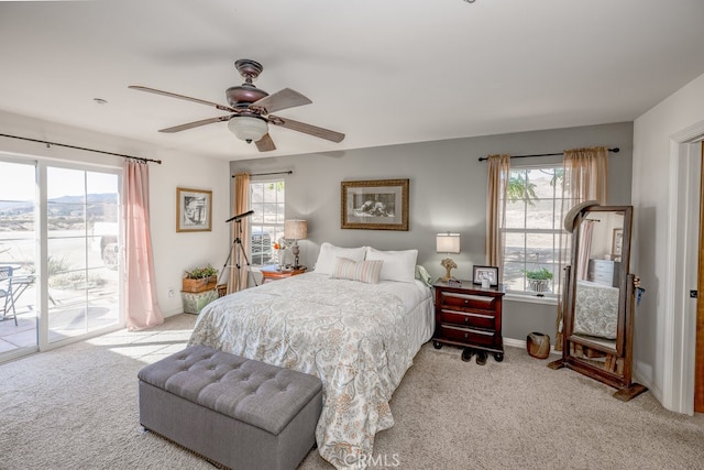 bedroom with access to outside, light colored carpet, and ceiling fan