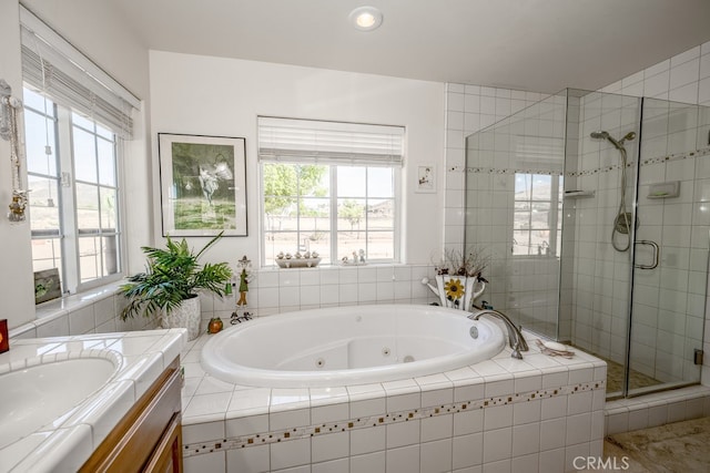 bathroom with independent shower and bath and vanity