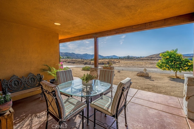 view of patio / terrace featuring a mountain view