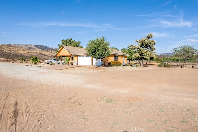 ranch-style house featuring a mountain view and a garage