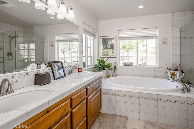 bathroom with independent shower and bath, vanity, tile patterned floors, and plenty of natural light