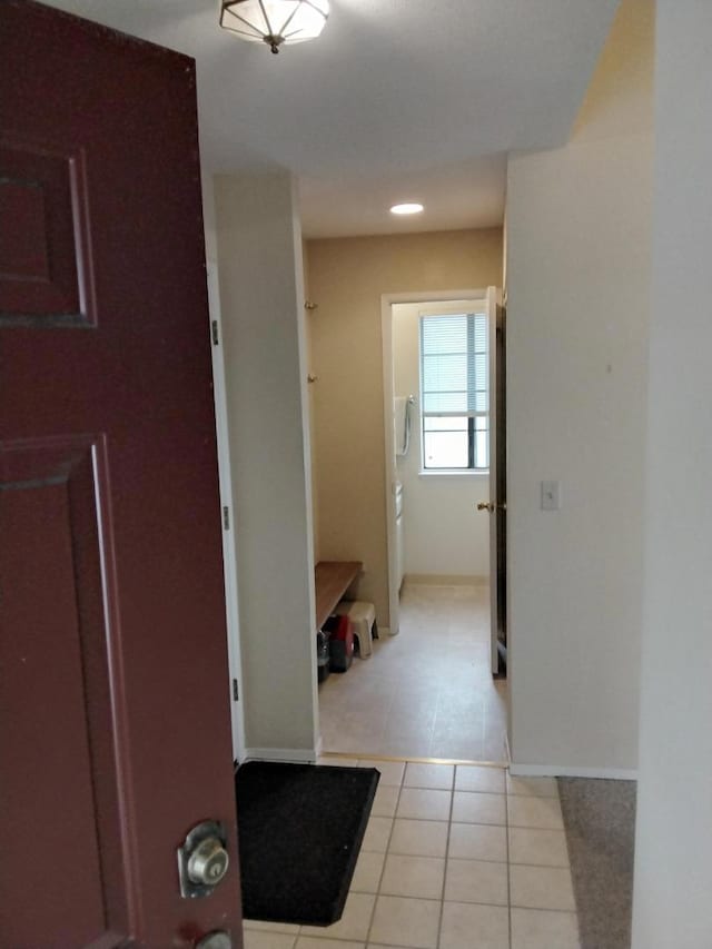 hall with light tile patterned floors