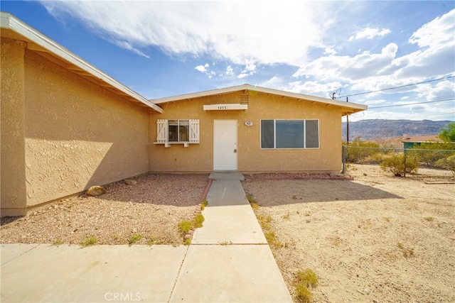 doorway to property with a mountain view and a patio area