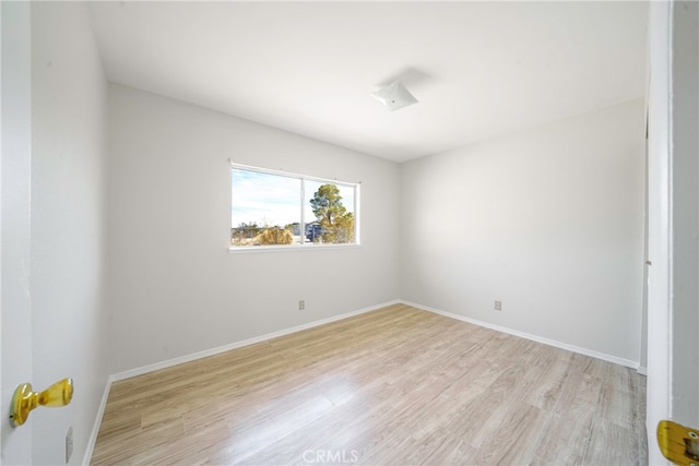 empty room with light hardwood / wood-style flooring